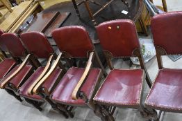 A set of early 20th century dining chairs with oak frames and studded red leather seats