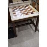 A heavy brass effect framed stone cut and inlayed chess or games board also ideal side table