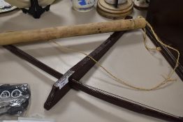 A small naive native crossbow and arrow in quiver