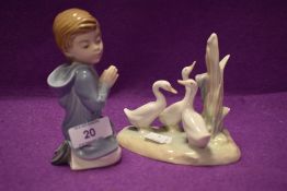 Two Lladro Nao figurines one of boy in prayer the other of three geese.AF.