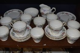 A collection of around thirty two pieces of Paragon Bridal rose, including cups and saucers, side