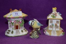 Two Coalport cottages and a Beswick blue tit.