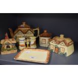 A collection of hand painted country cottage ceramics including tea pot, cheese dome, lidded sugar