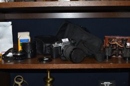 A Pentax K1000 camera with a Pentax A 50mm lens and Vivitar Macro Focusing Zoom 28-200mm lens as