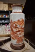 A large vintage oriental vase with wooden base having iron red hand painted design of village and
