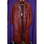 A vintage full length red leather coat with belt.around a small to medium size.
