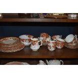 A collection of Wellington china having transfer pattern in russet tones with hand tinted floral and