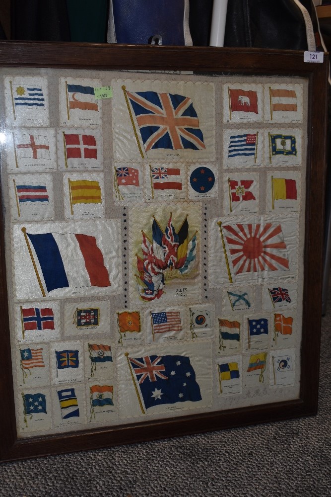 A framed collection of vintage flag silk cigarette cards.