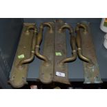 Four vintage brass door handles with integral finger plates.