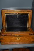 A late Victorian golden oak veneered mahogany writing slope, having brass corner protectors and