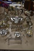 A varied lot of plated items including tea and coffee pots, toast rack, knife rests and more.