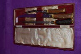 A vintage boxed horn handled carver set.