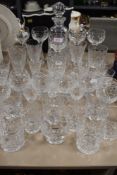 A collection of glass ware,some cut and etched including decanters, wine glasses, tumblers and