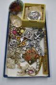 A selection of vintage costume brooches including diamante, nautical, mother of pearl, Coalport etc