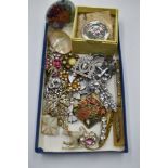 A selection of vintage costume brooches including diamante, nautical, mother of pearl, Coalport etc