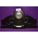 An art deco bronzed mantel clock having silver dial of stepped design with wild cats / Jaguars to