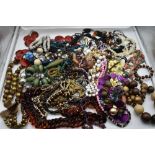 A large selection of costume jewellery necklaces including metal, wood, simulated pearls, cord etc