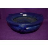 An antique art nouveau iridescent mottled blue bowl having triple handle and footed base 29cm across