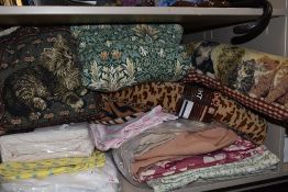 A mixed lot of retro and modern bedding and textiles including draught excluders and cushions.