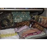 A mixed lot of retro and modern bedding and textiles including draught excluders and cushions.