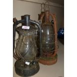 Two vintage storm lanterns.