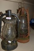 Two vintage storm lanterns.