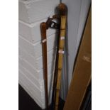 Thee vintage walking canes/ sticks and a ladies golf putter, made in Edinburgh.