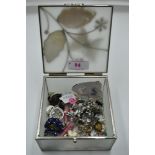 A decorative box containing a selection of stud and clip fashion earrings etc