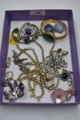 A selection of costume jewellery including diamante, bangle watch, brooches, religious charm etc