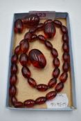 A string of cherry amber style graduated beads having broken barrel clasp, with 3 extra beads