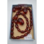 A string of cherry amber style graduated beads having broken barrel clasp, with 3 extra beads