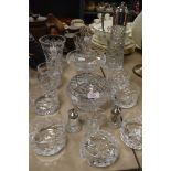 A collection of glassware amongst which are a decanter with plated handle, rose bowls and cruet.