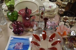 A selection of vintage and modern art glass including plates, bowls and vases.