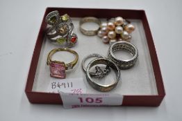 Seven assorted white metal dress and band rings stamped 925 including multi pearl, cubic zirconia,