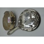 An HM silver dressing table hand mirror having moulded bow detail and an HM silver dressing table