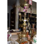 A large brass and glass shisha pipe.