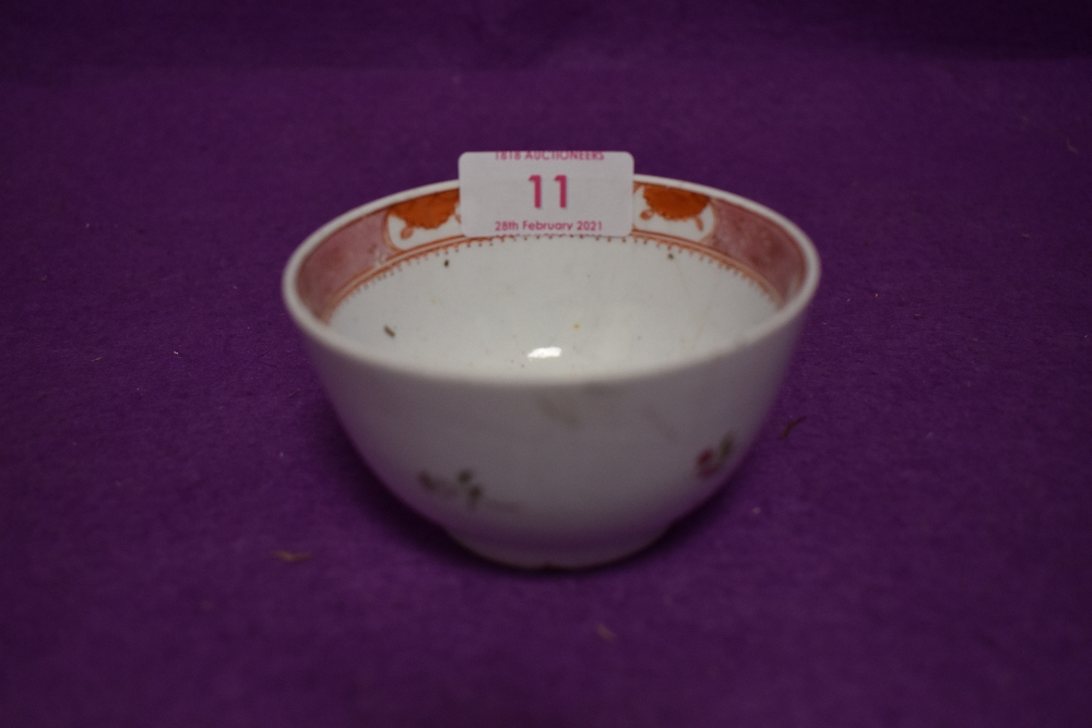 An antique ceramic tea bowl having iron red glaze