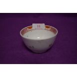 An antique ceramic tea bowl having iron red glaze