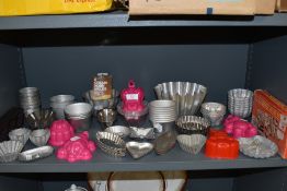 A huge array of vintage kitchen moulds amongst which are cream horn moulds,jelly moulds and much