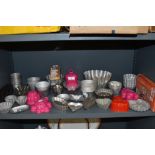 A huge array of vintage kitchen moulds amongst which are cream horn moulds,jelly moulds and much