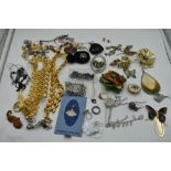 A selection of costume jewellery including brooches, earrings, Napier gold plated necklaces, etc