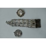 A HM silver seven bar gate bracelet of traditional form and two white metal brooches