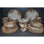 An antique part tea service by Sutherland china having green and red colour way