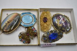 A small selection of vintage costume jewellery brooches including ceramic scenes and a St