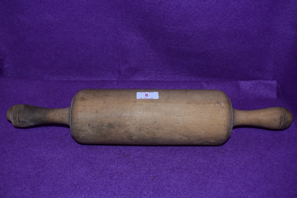 An farm house kitchen style rolling pin of large proportions in beech wood 50cm long