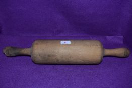 An farm house kitchen style rolling pin of large proportions in beech wood 50cm long