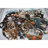 A large selection of costume jewellery necklaces including glass beads, simulated pearls, cord etc