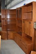 Four sections of vintage teak G plan wall units, including corner pieces, glazed display and desk or