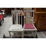 A set of three painted dining chairs, mixed seats