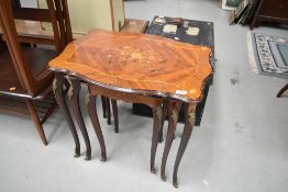 A nest of three continental style tables having brass elephant head decoration to legs with